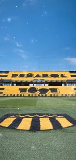 Peñarol Stadium with vibrant blue sky and iconic design.