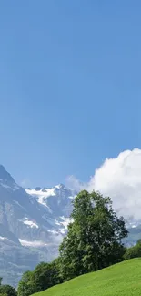 Mountain landscape with green hills under a clear blue sky.