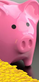 Glossy pink piggy bank with gold coins on black surface.