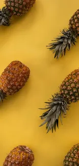 Yellow background with pineapples pattern wallpaper.