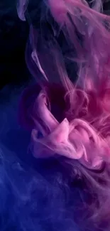 Pink and blue smoke creating an abstract and colorful wallpaper design.