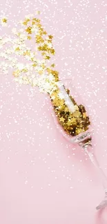 Champagne glass with gold stars on pink background.