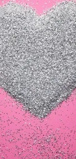 Mobile wallpaper with a silver glitter heart on a pink background.