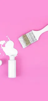 Pink wallpaper with a white paintbrush and paint spill.