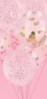 Pink balloons with confetti on pastel background.