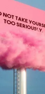 Pink billboard with motivational quote and cloud puff under blue sky.