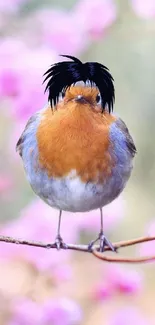 Bird sitting on branch with pink floral background.