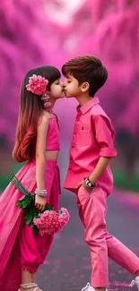 Two children in pink outfits share a sweet moment surrounded by blossoms.