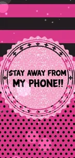 Bold pink phone wallpaper with stripes and polka dots, saying 'Stay away from my phone'.