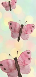 Watercolor pink butterflies with a soft bokeh background.