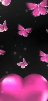 Pink butterflies and heart on black background.