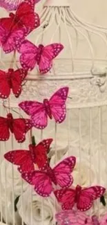 Pink butterflies on a white birdcage with floral accents.