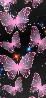 Pink butterflies float in a starry night sky wallpaper.