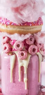 Vibrant pink dessert shake with donut and cotton candy.