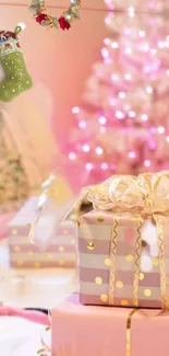 Pink Christmas gifts with a glowing tree and stockings in soft focus.