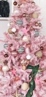 Pink Christmas tree with decorations and ornaments.