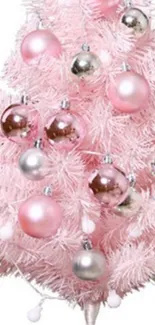 Pink Christmas tree with metallic ornaments.