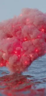 Mesmerizing pink cloud floating over calm ocean.