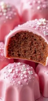 Pink frosted dessert with sprinkles.