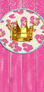 Pink background with golden crown on a wooden texture.