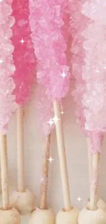 Pink crystal candy sticks arranged vertically, creating a playful pattern.