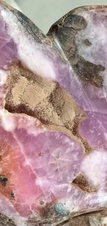 Close-up of pink crystal rock texture with natural patterns.