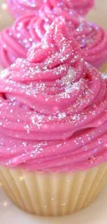 Vibrant pink cupcake with glittery frosting.