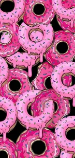 Bright pink donuts with sprinkles on wallpaper.