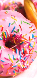 Pink donuts with colorful sprinkles close-up.