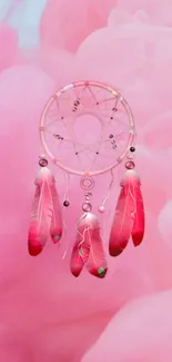 Pink dreamcatcher with feathers on a pastel background.