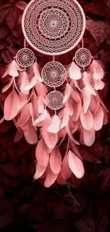 Pink dreamcatcher with feathers on red leaf background wallpaper.