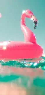 Pink flamingo float on turquoise sea.