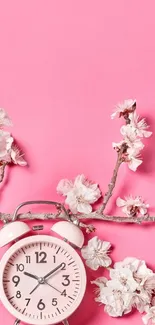 Pink floral wallpaper with alarm clock and cherry blossoms.