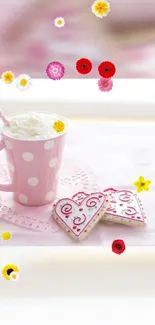 Pink cup with cream and floral cookies on a delicate background.