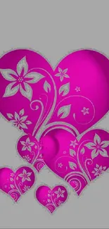 Pink heart wallpaper with floral designs.