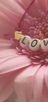 Mobile wallpaper with pink flower and 'Love' beads.