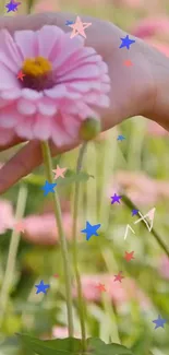 Pink flower hand with colorful stars wallpaper.