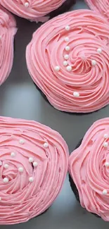 Pink frosted cupcakes with sprinkles, perfect for dessert lovers' wallpaper.