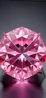 Pink gemstone shining on dark background