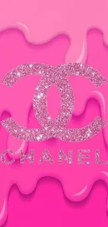 Pink wallpaper with a glittery logo design.