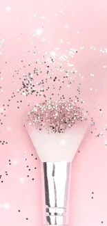 Pink background with glittery makeup brush.