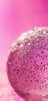 Close-up of a pink sphere with glitter on a vibrant background.