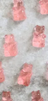 Pink gummy bear wallpaper with a cute aesthetic on a marble background.