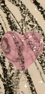 Reflective pink heart with a textured beige background.