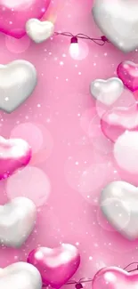 Pink heart balloons with lights and bubbles on a festive wallpaper.