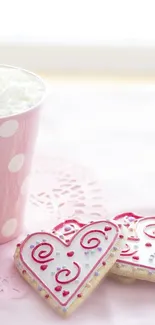 Pink heart cookies and a polka dot mug on a pastel background.