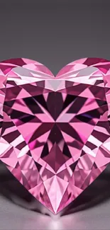 Pink heart-shaped diamond with intricate facets on a mobile wallpaper.