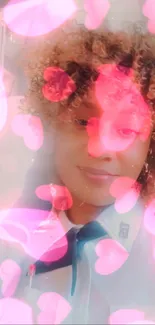 Curly-haired person with pink hearts filter overlay.