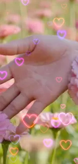 Hand touching pink flowers with heart shapes overlay.