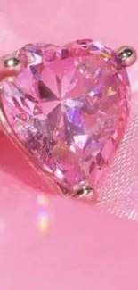 Sparkling pink heart gemstone on silky background.